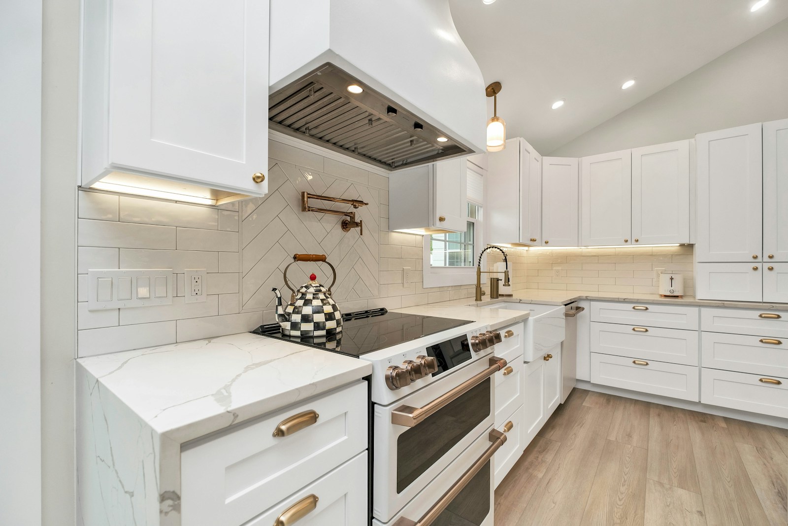 Chimney-style vent hood over professional cooktop